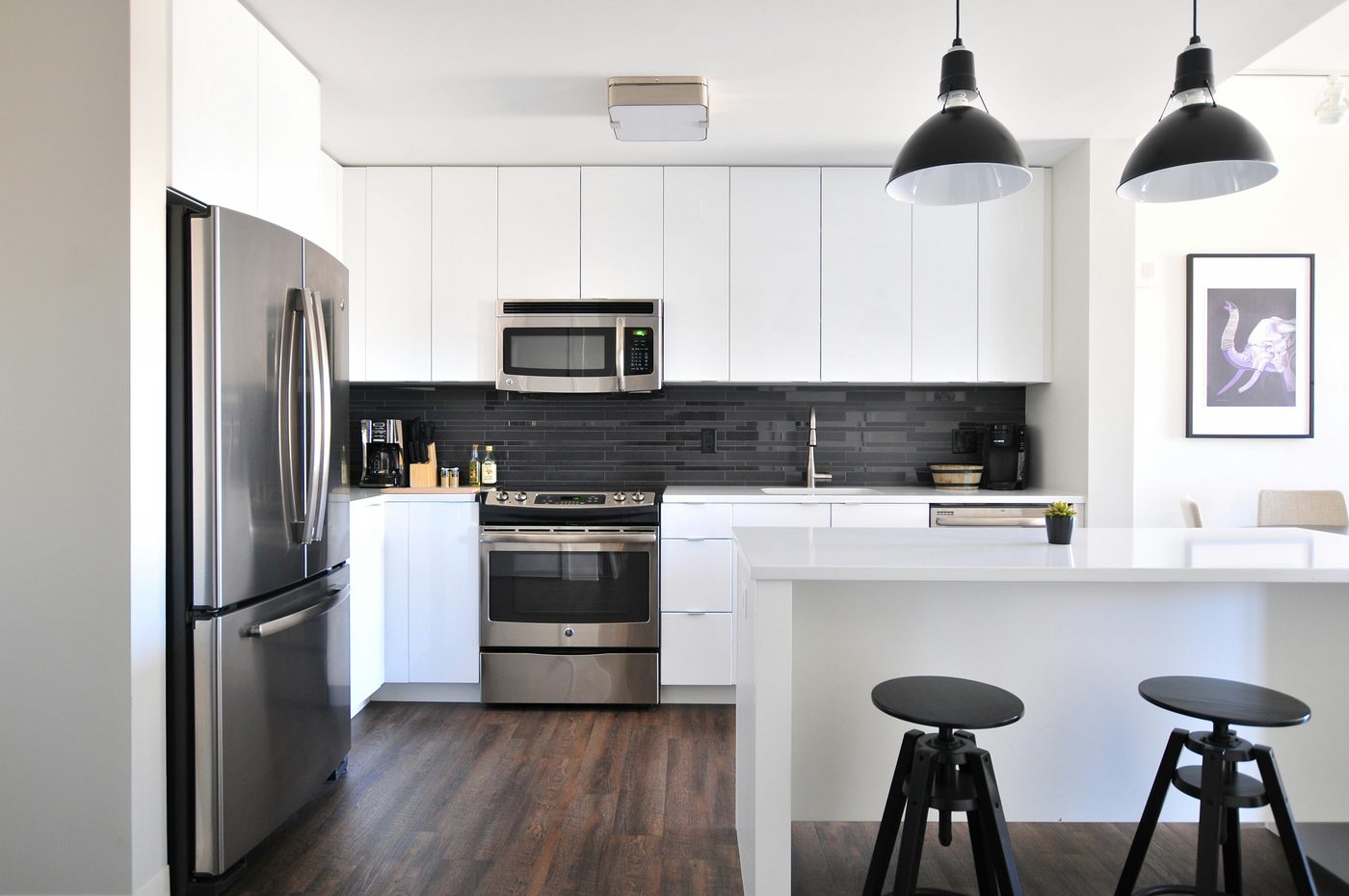 Modern white kitchen with stainless appliances