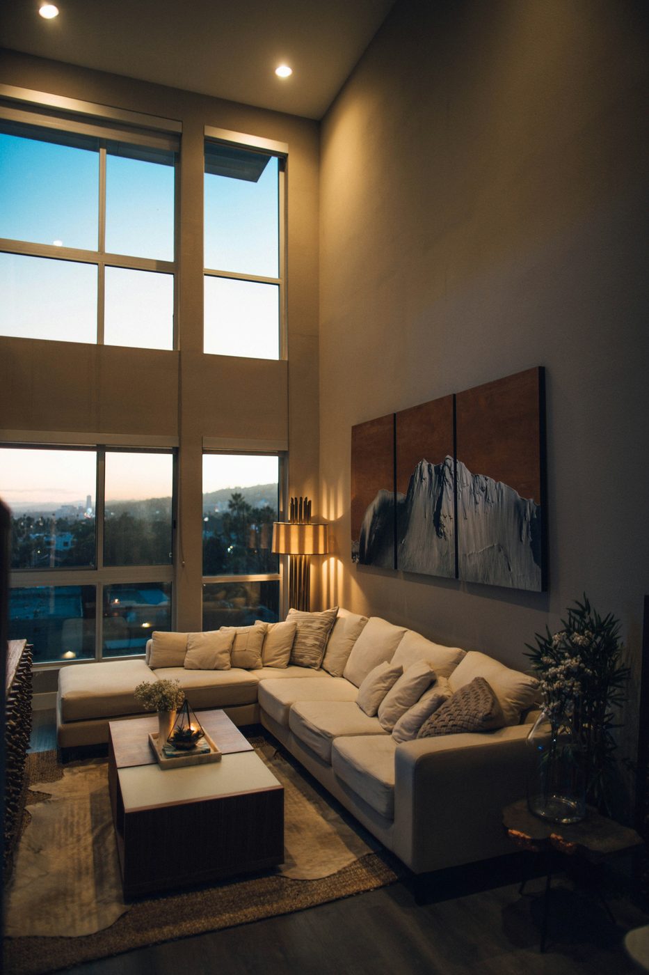 Loft living room with high ceilings and city view